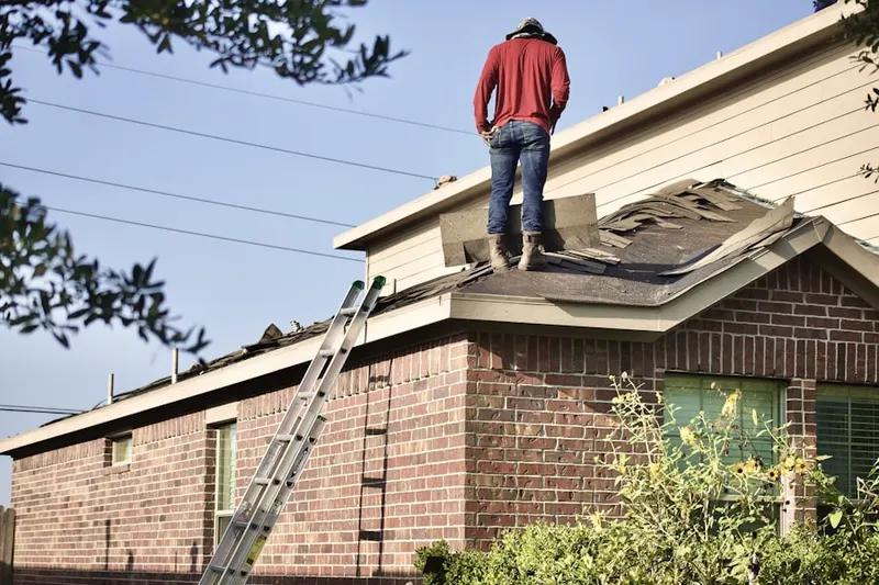 Professional roofer working on a residential roof in Doty